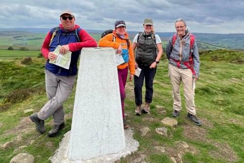 Amy Baron-Hall on Hill and Moorland Leader 3 with the group at a trig point